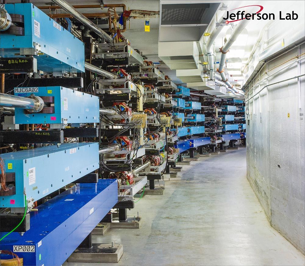 A view of one of the underground tunnel arcs at CEBAF, showing the accelerator infrastructure used to conduct research.