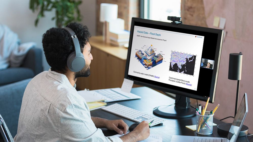 Man attending an online event at his desk.
