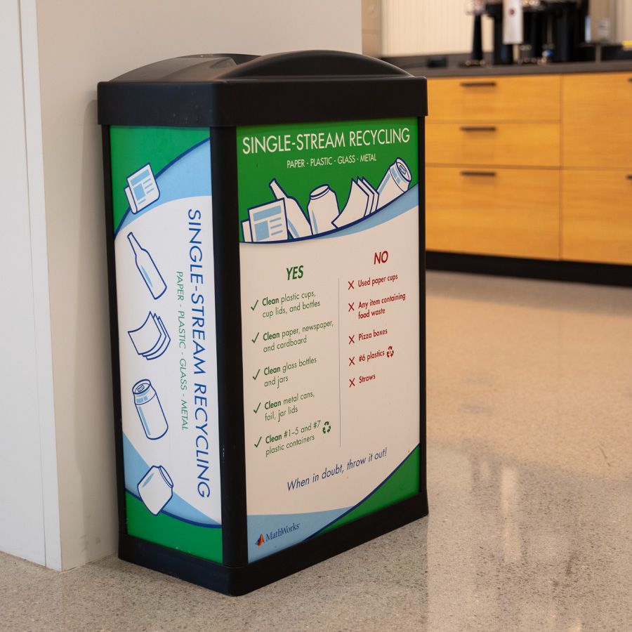 A bin for single-stream recycling with details about what can and cannot be deposited.