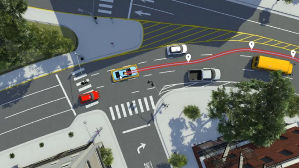 Vehicles in a RoadRunner Scenario example navigating through a complex intersection.